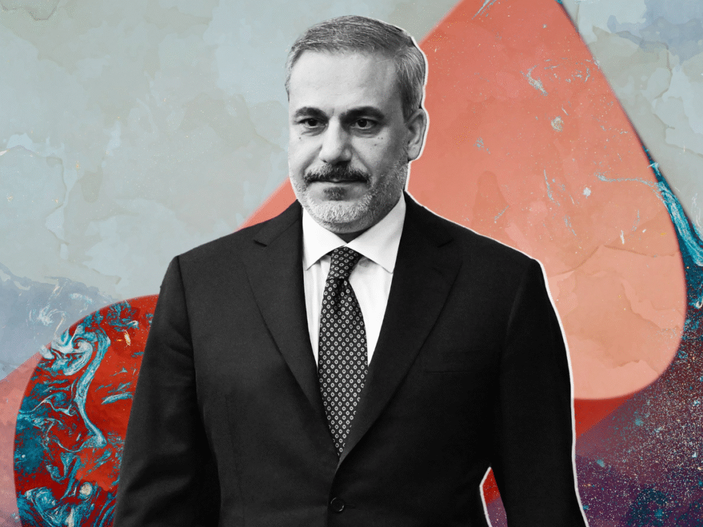 Portrait of Turkey’s foreign minister wearing a dark suit and tie, set against a stylized abstract background.